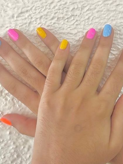 Another fun look for a kids' manicure. This colorful set features a different bright, summery color on each nail for a playful and cheerful style.