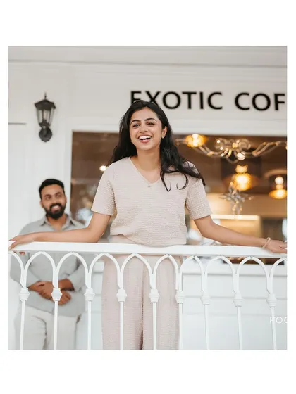 A duplicate of image 62, a bright and happy portrait of the bride-to-be on a cafe balcony.