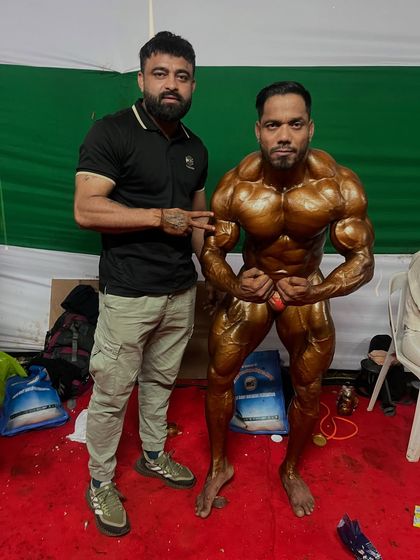 Striking a most muscular pose with my coach. His presence gives me the confidence to give my all.