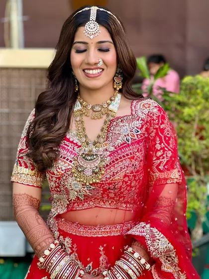 A closer look at Bhavi's minimal and elegant bridal makeup. The soft glam style with defined eyes and a neutral lip perfectly complemented her intricate red lehenga and jewelry.