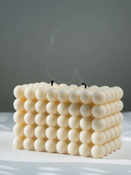 A large bubble candle, just extinguished, showing the clean burn of our soy wax. A simple, happy piece for any home.