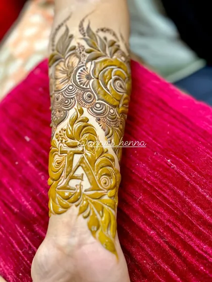 A still image showing the finished initial 'A' design. You can clearly see how the bold lines of the letter are balanced by the delicate floral work around it.