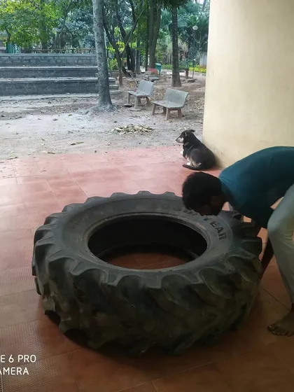 A moment of preparation before the tire flip. Focus is required for both safety and effectiveness.