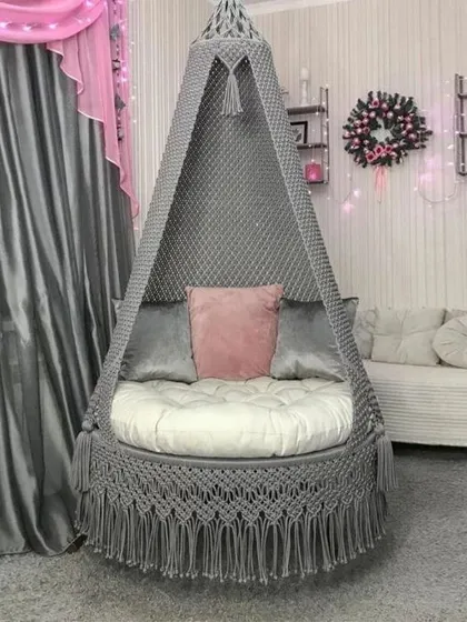 This grey large bed swing is a perfect addition to your home. It's handwoven with cotton yarn and supported by a strong iron frame for durability.