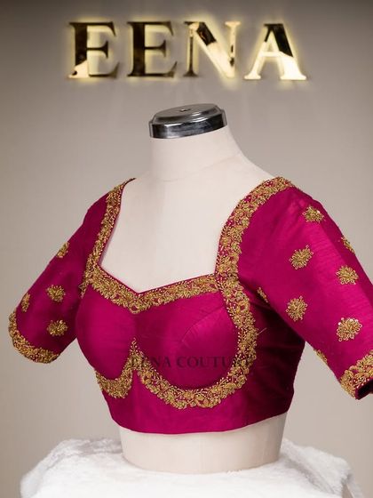The classic Katori blouse is all about the perfect fit and timeless charm. This version in magenta raw silk is adorned with simple but elegant gold butti embroidery, making it a versatile choice for any traditional event.
