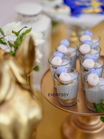 A close-up of a golden horse bust and delicate dessert cups, showcasing the attention to detail in every element.