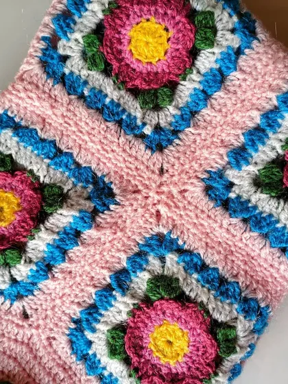 A close-up of the floral granny squares that make up the Lydia blanket. Each square is like a small work of art.