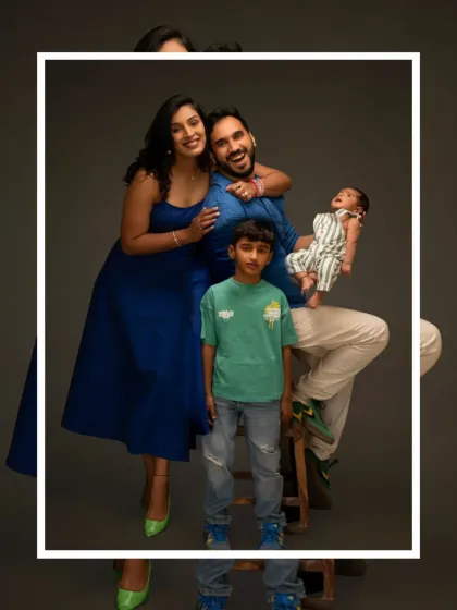 Another joyful pose from the same family of four, showcasing their fun-loving connection in a classic studio setting.