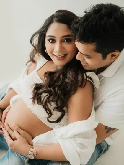 A close up of this beautiful couple. The way they are looking at the camera and each other shows their shared joy and excitement for their new arrival.