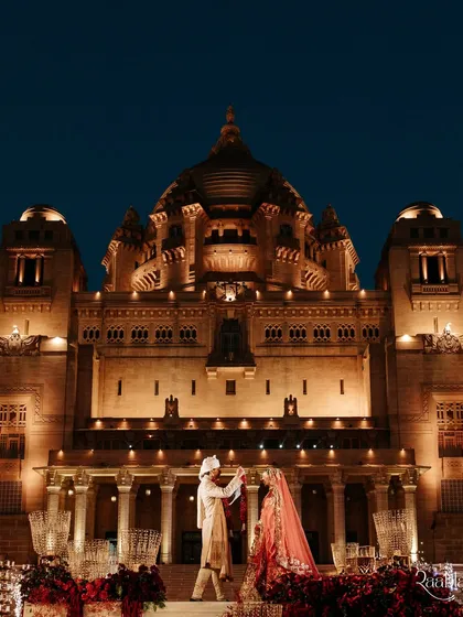 The grandeur of Umaid Bhawan Palace illuminated for Amala and Aditya's varmala ceremony. We specialize in capturing the epic scale of palace weddings, turning these moments into cinematic history.