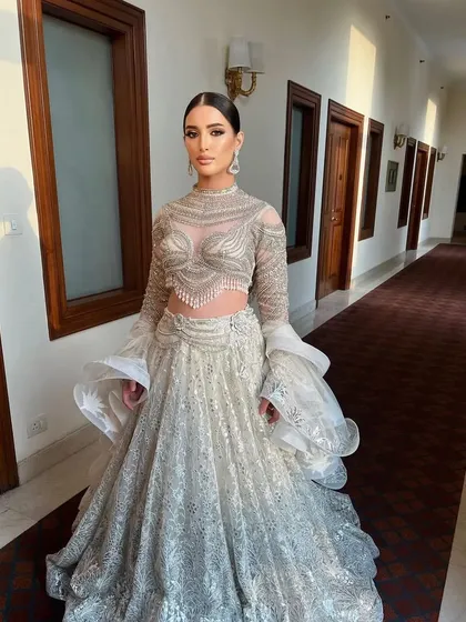 The sunlight catching the silver details creates a magical glow. This is a truly unforgettable look for a special occasion.