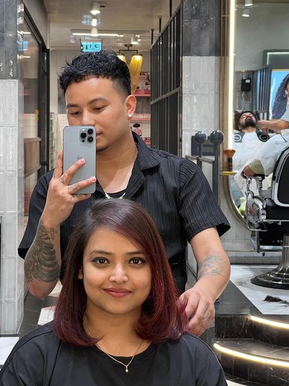 Everything feels better after a fresh hair color. This client is rocking a new red bob, looking confident and happy.