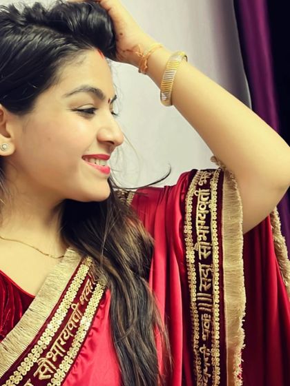 A happy moment captured in my red Diwali saree. The custom border with "Sada Saubhagyavati Bhava" embroidery makes this outfit truly special and meaningful.