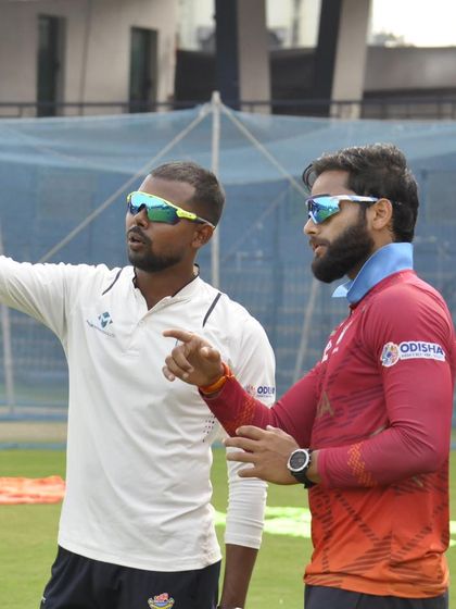 Driven by purpose. A candid shot of me discussing strategy with a player during a net session. My goal is to empower athletes with knowledge.