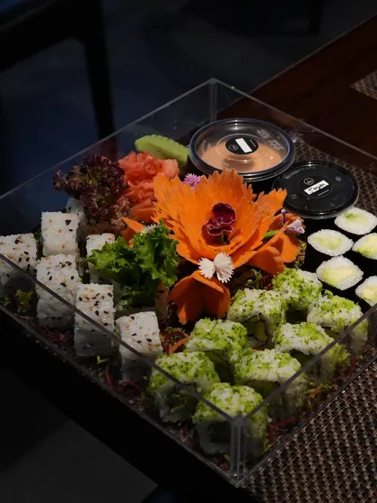 Our party platters are packed to impress, making them a perfect gift. This arrangement includes a mix of our popular vegetarian rolls, complete with pickled ginger, wasabi, and our house-made sauces.