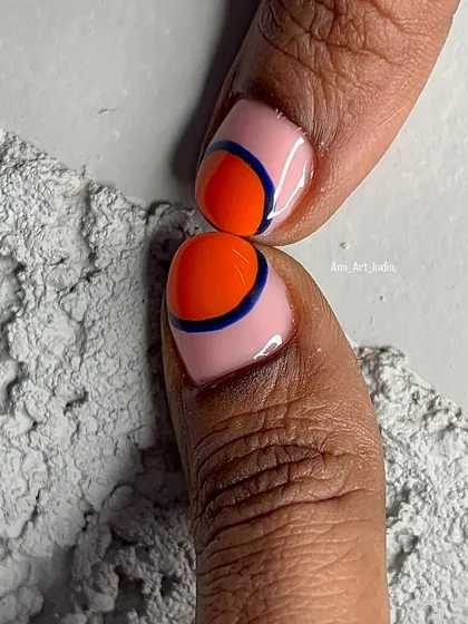 A close-up of a bold, graphic design with orange, pink, and a dark blue line.