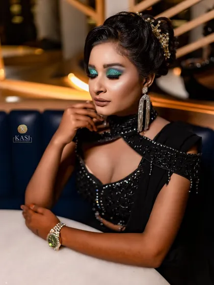 Another angle of the black beauty look, showing the intricate hairstyle and earrings.