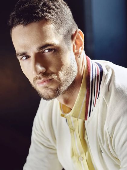 A great portrait from the Basics Life campaign. The off-white bomber jacket with striped collar detail, layered over a yellow shirt, creates a clean and modern aesthetic that is both stylish and commercially appealing.