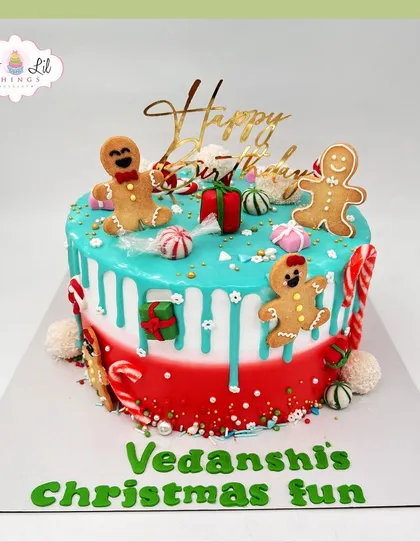 A festive Christmas-themed birthday cake for Vedanshi, decorated with gingerbread men and candy canes.