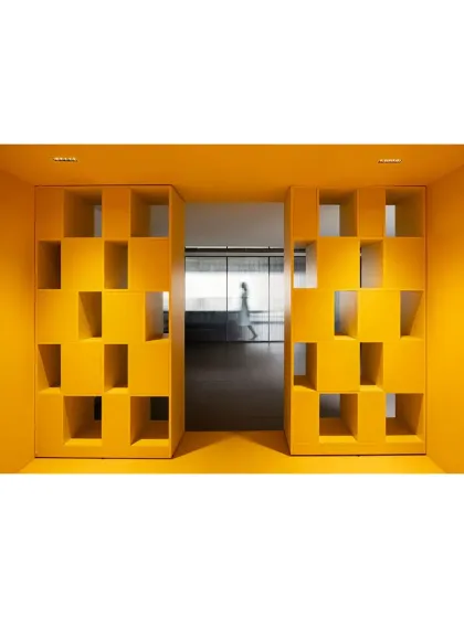 A geometric, three-dimensional wall feature in 'The Amber Encase' acts as a porous screen, creating a playful sense of entry and separation.