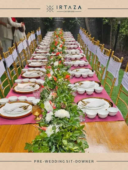 For more formal occasions like a pre-wedding dinner, I can arrange an exquisite sit-down meal. This setup features a long, beautifully decorated table with floral runners, elegant place settings, and dedicated service for a truly memorable fine dining experience at home.