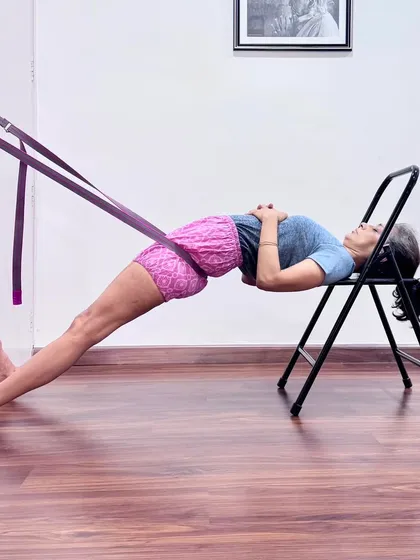This supported backbend uses a chair and wall ropes to create traction in the spine. This setup helps to open the chest and shoulders while keeping the lower back passive, making it a deeply restorative and beneficial posture.