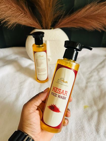 Holding my Kesar Face Wash. Enriched with saffron, this luxurious cleanser helps brighten the complexion and reduce pigmentation for radiant skin.