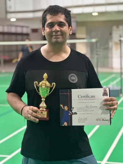 Our training programs are designed for all ages, including dedicated adults. Here is one of our adult players, Amar, with his trophy and certificate from the Racket Rider Tournament after winning in the doubles category.