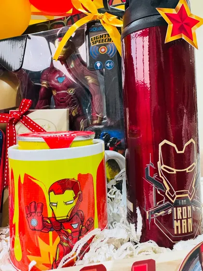 A close-up of the Iron Man themed goodies, including a branded sipper bottle and mug, perfect for a true Marvel fan.