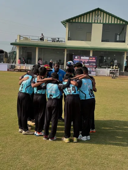 A team that huddles together, wins together. A quiet moment of focus and strategy with the coach before a big game. We believe in building unity and discipline on and off the field.