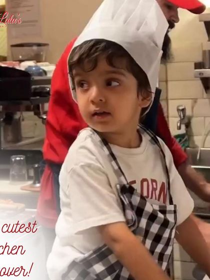 The cutest kitchen takeover. This little one, all geared up in his apron, is ready to learn the secrets of pizza making.