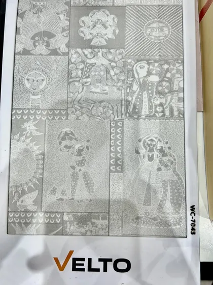 A close-up of a unique, traditional-patterned wallpaper or laminate sheet being considered for a project.