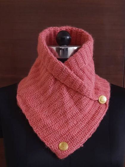 This lovely coral-pink crochet neck warmer adds a pop of color to grey winter days. It's handcrafted from soft wool to feel gentle against your skin.