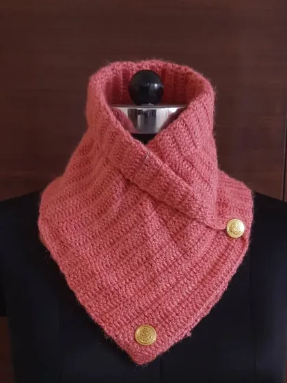 This lovely coral-pink crochet neck warmer adds a pop of color to grey winter days. It's handcrafted from soft wool to feel gentle against your skin.