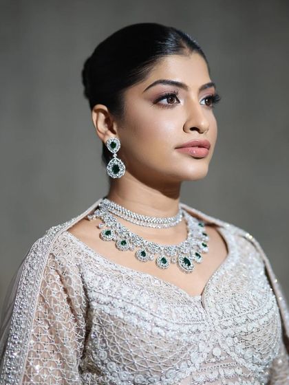 A close-up that captures the exquisite craftsmanship of the necklace, with its alternating layers of white and green stones.