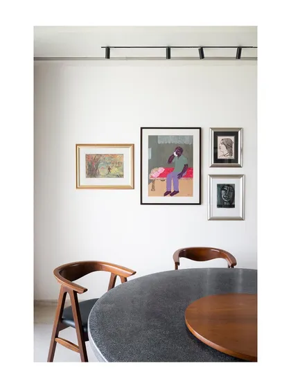 For clients who are collectors, we design spaces that honor their art. This dining area at our Collectors House project features a curated gallery wall, integrating priceless works by Indian masters into the daily life of the home.