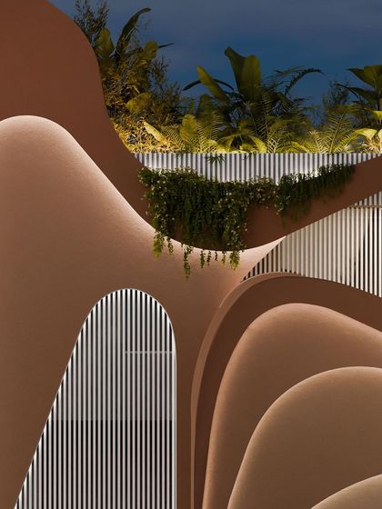 A detail of the upper levels of the facade, where the curves and textures create a rich, tactile surface.