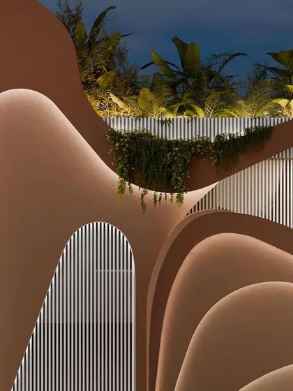 A detail of the upper levels of the facade, where the curves and textures create a rich, tactile surface.