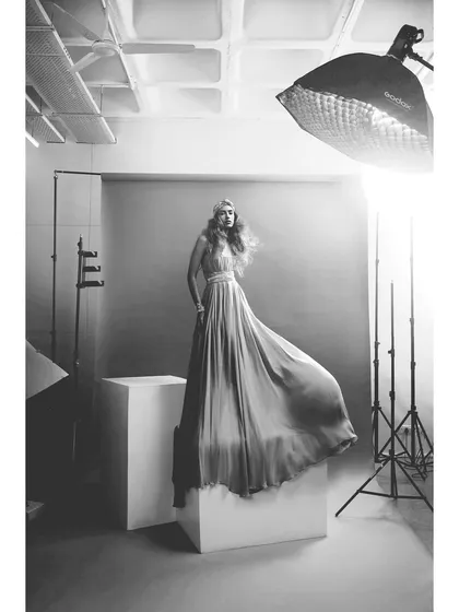 The same studio setup with the Rudraksh Dwivedi gown, presented in black and white. This version highlights the dress's flow and form without the distraction of color.