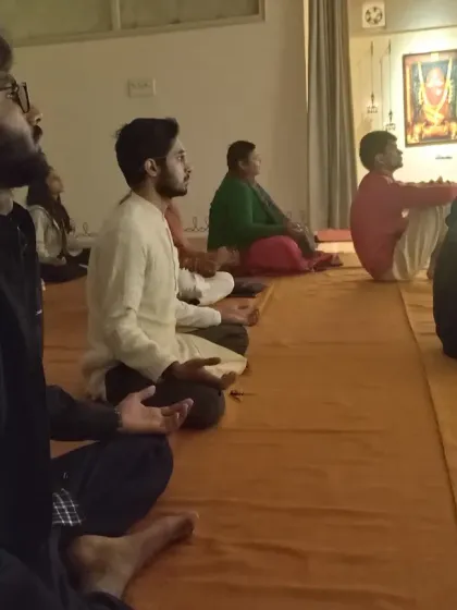 The faces of the participants reflect the deep, meditative state of the Mauni Amavasya gathering. The space was alive with the fragrance of offerings and the glow of lamps.