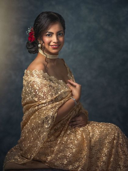 A duplicate of image 91, this portrait is a celebration of traditional beauty and timeless style. The golden saree glows under the soft studio light, creating a warm and elegant image.