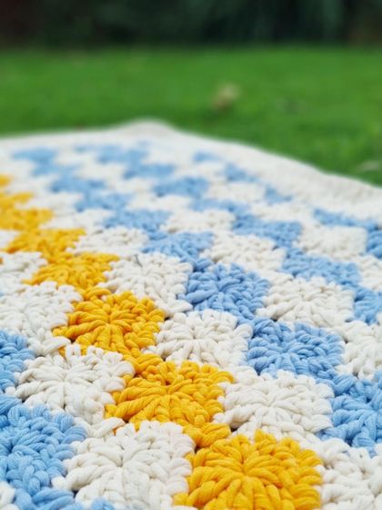 A close-up of the textured stitches on the baby blanket. I use a cotton-mix yarn that is both soft and durable, perfect for a well-loved blanket.