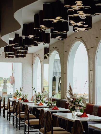 The restaurant's interior, with tables decorated with simple yet elegant boho-floral centerpieces, ensuring the theme carries through the entire venue.