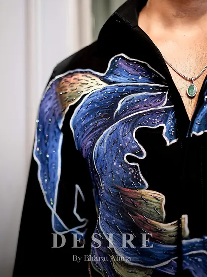 A detailed look at the hand-painted and embroidered abstract wave design. Notice the subtle scattering of crystals that mimic a starry night sky.