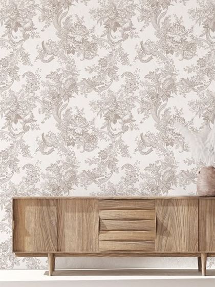 This intricate floral damask pattern in a subtle beige tone brings a touch of Parisian elegance to the room. It serves as a sophisticated backdrop for the wooden sideboard, enhancing its classic appeal.