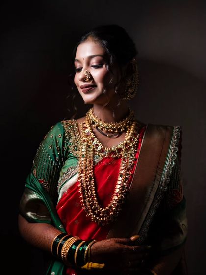 A dramatic bridal portrait using focused light to highlight the bride's beautiful features and traditional jewelry.