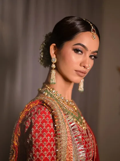 A close-up portrait showcasing the sharp, clean lines of the eye makeup and the flawless skin finish. This look is perfect for brides who want a bold yet sophisticated wedding day appearance.