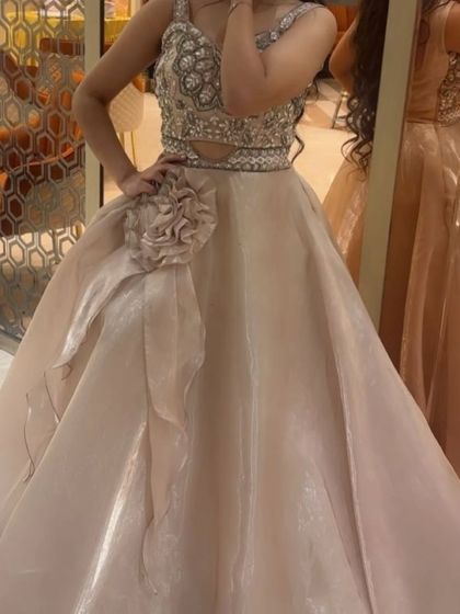 A final look at the beige gown, highlighting the detailed craftsmanship on the bodice. This is a designer-quality piece you can rent for an affordable price.