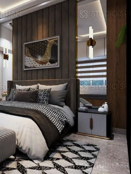 Another angle of the dark-themed bedroom, showing a large mirror panel next to the bed which helps to reflect light and make the space feel larger.
