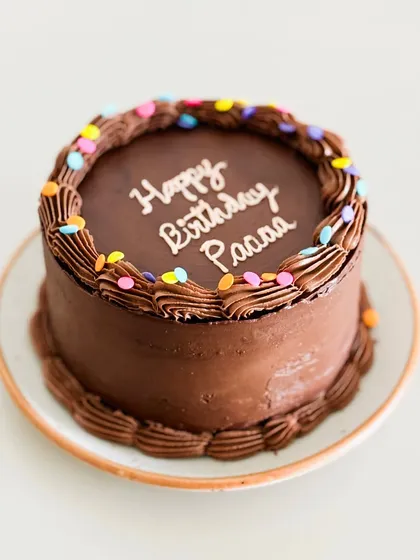 Nothing beats the timeless joy of a simple, classic chocolate cake for a birthday. This one is rich, moist, and decorated with fun, colorful sprinkles.